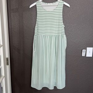 Woman’s summer green and white dress with pockets